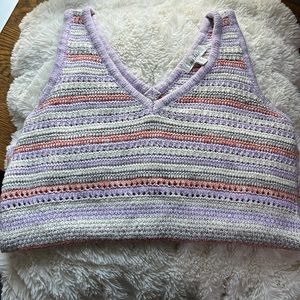 Purple, orange and grey striped sweater vest w/ a V cut neck.
